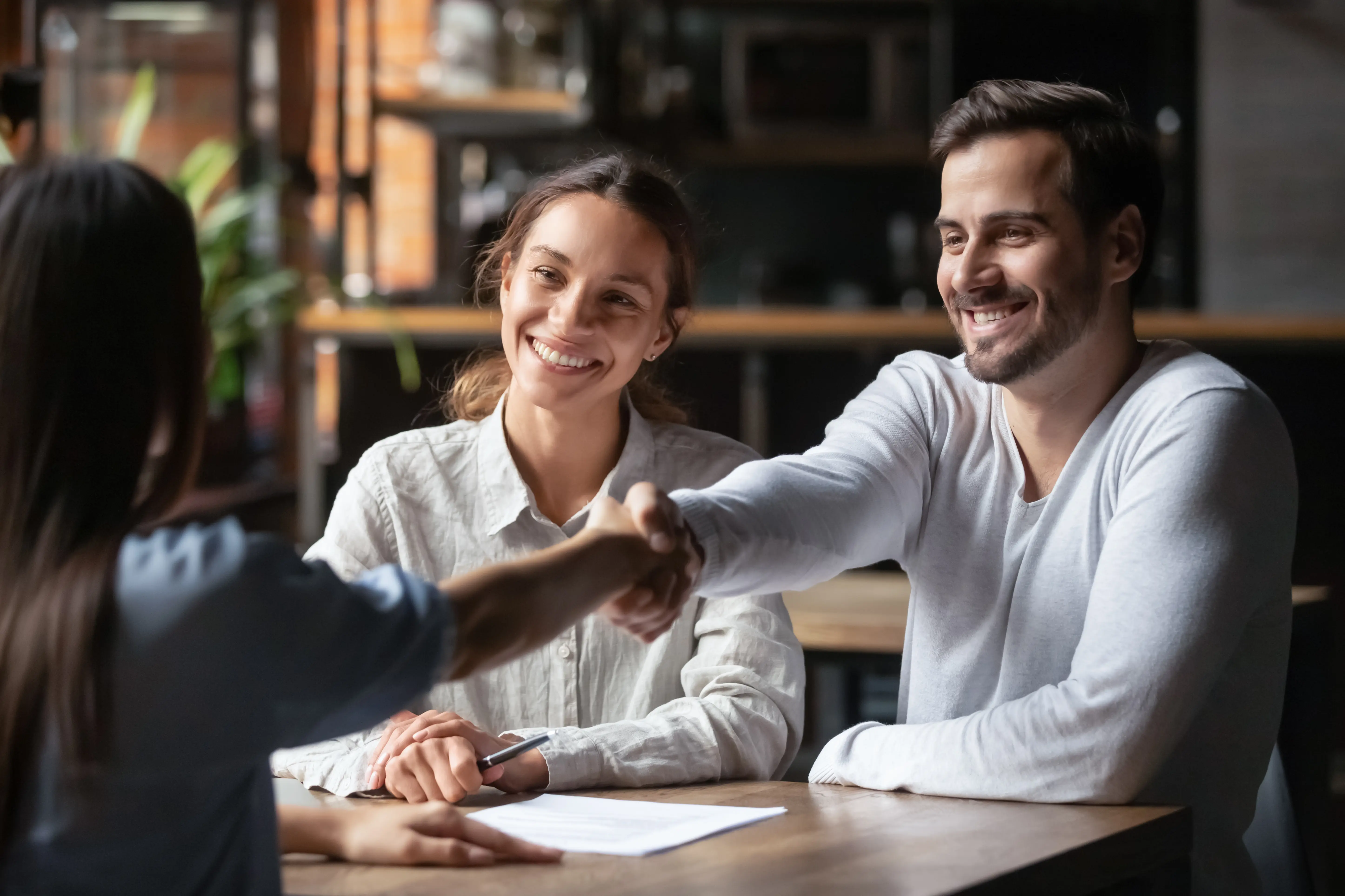 Broker Doing Handshake With Big Smile
